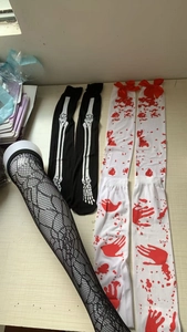 Detail of Halloween stockings set with bone print, bloody handprints and mesh texture