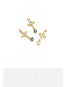 Macro view of cross pendant with emerald opal heart, 16x32mm 18k gold plated jewelry