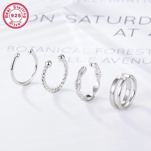 Macro detail of four S925 sterling silver ear cuffs with twisted and sleek textures