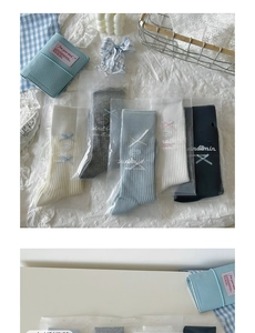 Detail of ballet style mid-calf socks with ribbon bows in five assorted colors