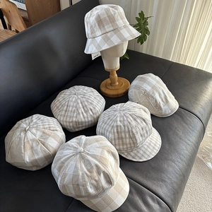 Close-up of beige plaid hats in linen fabric showing various styles and textures