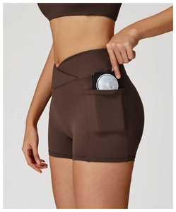 Detail of high-waist yoga shorts with crossover waistband and side phone pocket