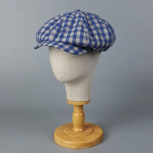 Detailed texture of blue and grey checkered newsboy cap on a professional mannequin