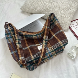 Detail of vintage plaid hobo bag in brown and blue tweed with adjustable strap