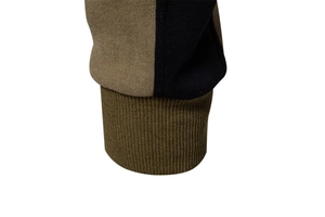 Detail of ribbed knit cuffs featuring a color-block design in tan, black, and olive green
