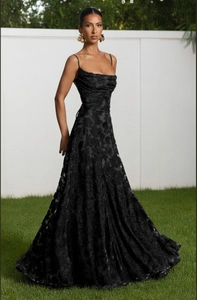Detailed view of the black jacquard evening dress with delicate floral texture and straps