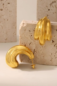 Macro detail of high-polished multi-layer C-shape earrings with 18K gold-plated finish