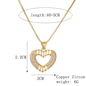 Detailed view of gold plated heart pendant with zircon stones and 2x2.2cm dimensions