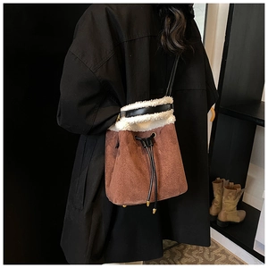 Brown suede bucket bag with white faux fur trim and drawstring closure detail