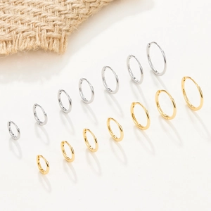Various sizes of minimalist S925 sterling silver hoop earrings in gold and silver