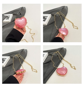 Detail of pink heart-shaped mini evening bag with geometric facets and golden chain
