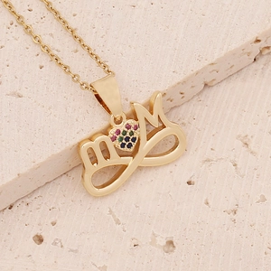 Macro view of 18K gold MOM heart necklace with colorful pavé cubic zirconia inlay