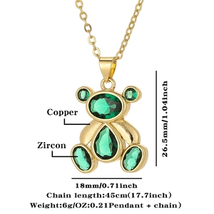 Detail view of gold-plated bear pendant with green zircon and size measurements