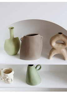 Artistic matte ceramic vases in sage green and taupe for modern home shelf decor