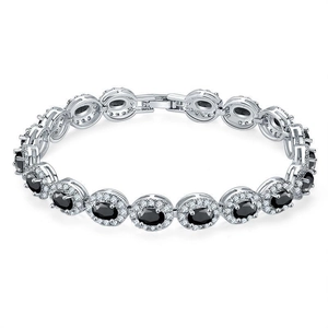Detail of silver-tone bracelet featuring black oval stones and halo diamond settings