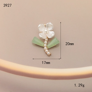 Macro detail of enamel flower charm with pearl core and leaves measuring 20mm by 17mm