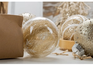 Close-up of 8cm champagne gold Christmas balls with glitter, pearls and snow motifs