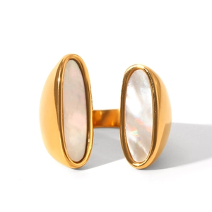 Detail shot of golden open ring with dual oval white shell inlays on white background