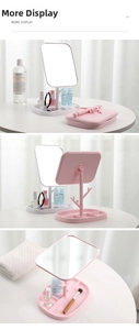 Detail view of makeup mirror with jewelry hooks and multi-grid storage base tray