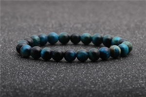 Macro detail of polished natural tiger eye beads with premium silky blue luster
