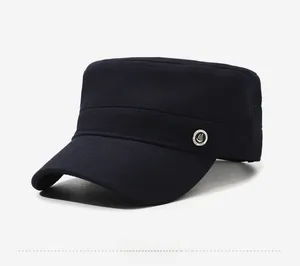 Side view detail of navy blue cadet cap featuring a metallic 'Good Luck' circular badge