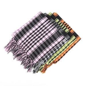 Detail of four colorful houndstooth tactical scarves with tassels on white background