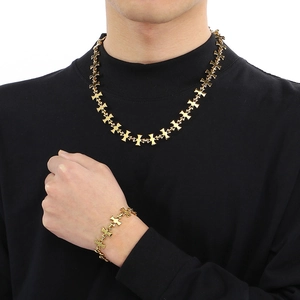 Men's gold titanium steel cross link chain necklace and bracelet set on male model