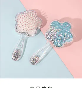 Detail of flower-shaped air cushion hairbrush with glitter stars in transparent casing