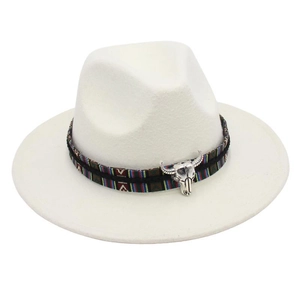 Detailed macro view of white felt fedora hat with ethnic woven band and bull skull charm
