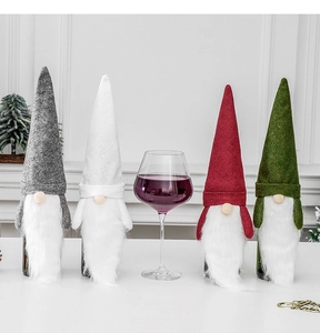 Set of four festive Christmas gnome wine bottle covers in grey, white, red, and green felt