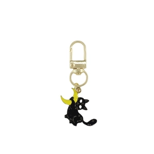 Gothic black cat clutching a yellow crescent moon keychain with golden star details