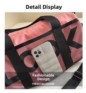 Detail of pink sports bag featuring a black mesh side pocket with OK print and phone storage