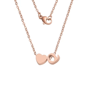 Detail of rose gold heart pendant and lowercase letter 'a' with lobster clasp