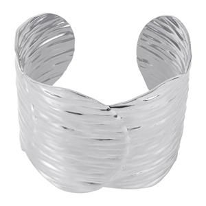 Macro shot of wide silver cuff bracelet with textured ripple design and open structure