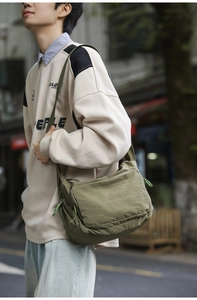 Close-up of military green waterproof nylon messenger bag with adjustable shoulder strap