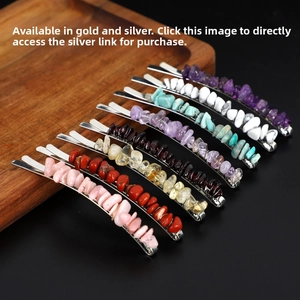 Detail view of seven colorful natural crystal stone hair clips on a wood tray