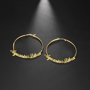 Golden stainless steel hoop earrings featuring Aquarius and Libra cursive text designs