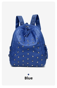 Detail of blue pebbled faux leather backpack with silver metal studs and zipper