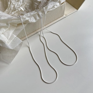 Close-up of S925 sterling silver snake bone chain necklace displayed on a gift box