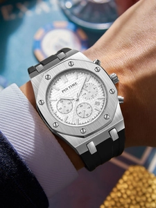Close-up of a silver octagonal chronograph watch with a white textured dial on wrist