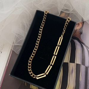 Gold-toned titanium Cuban link and rectangular chain necklace in a velvet jewelry box