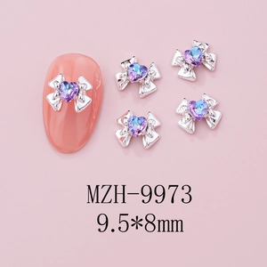 Macro detail of 9.5x8mm silver bow nail charm with gradient purple heart crystal