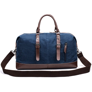Blue canvas and brown leather travel duffel bag with detachable shoulder strap