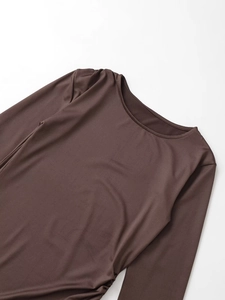 Detail view of dark brown round neck long sleeve tee with ruched texture and subtle sheen