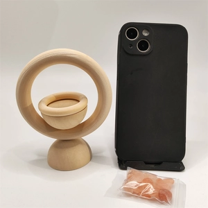 Vertical wooden essential oil diffuser set with pink salt stones and phone for scale