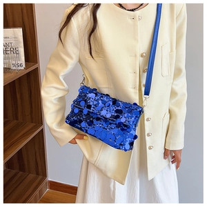 Detail of blue sequined crossbody bag showing sparkling large round sequins and texture