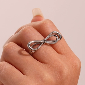 Polished silver bow knot open ring for women with minimalist wire design on index finger