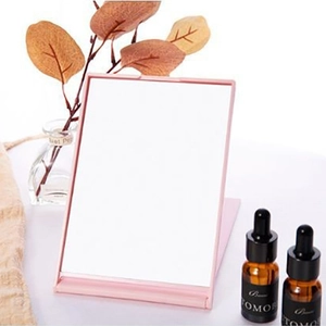 Portable pink folding makeup mirror with stand for desktop vanity and beauty touch-ups