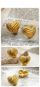 Macro detail of 18K gold heart earrings with wavy texture and central round zircon stones