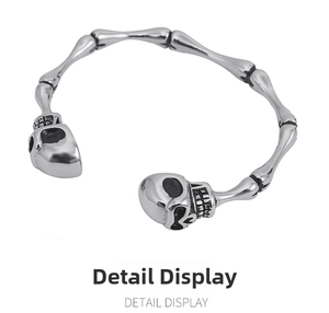 Macro shot of skull head terminals and skeletal bone texture on vintage silver bangle